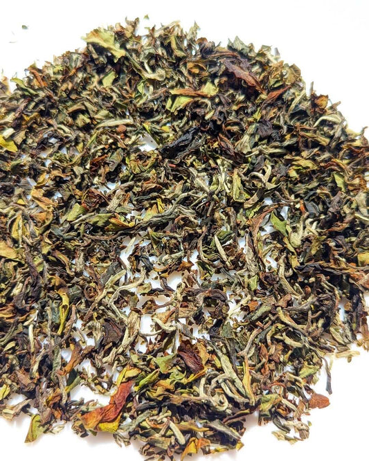 Close-up of Aambari AV2 Organic First Flush Black Tea leaves, showcasing their rich colors and textures.