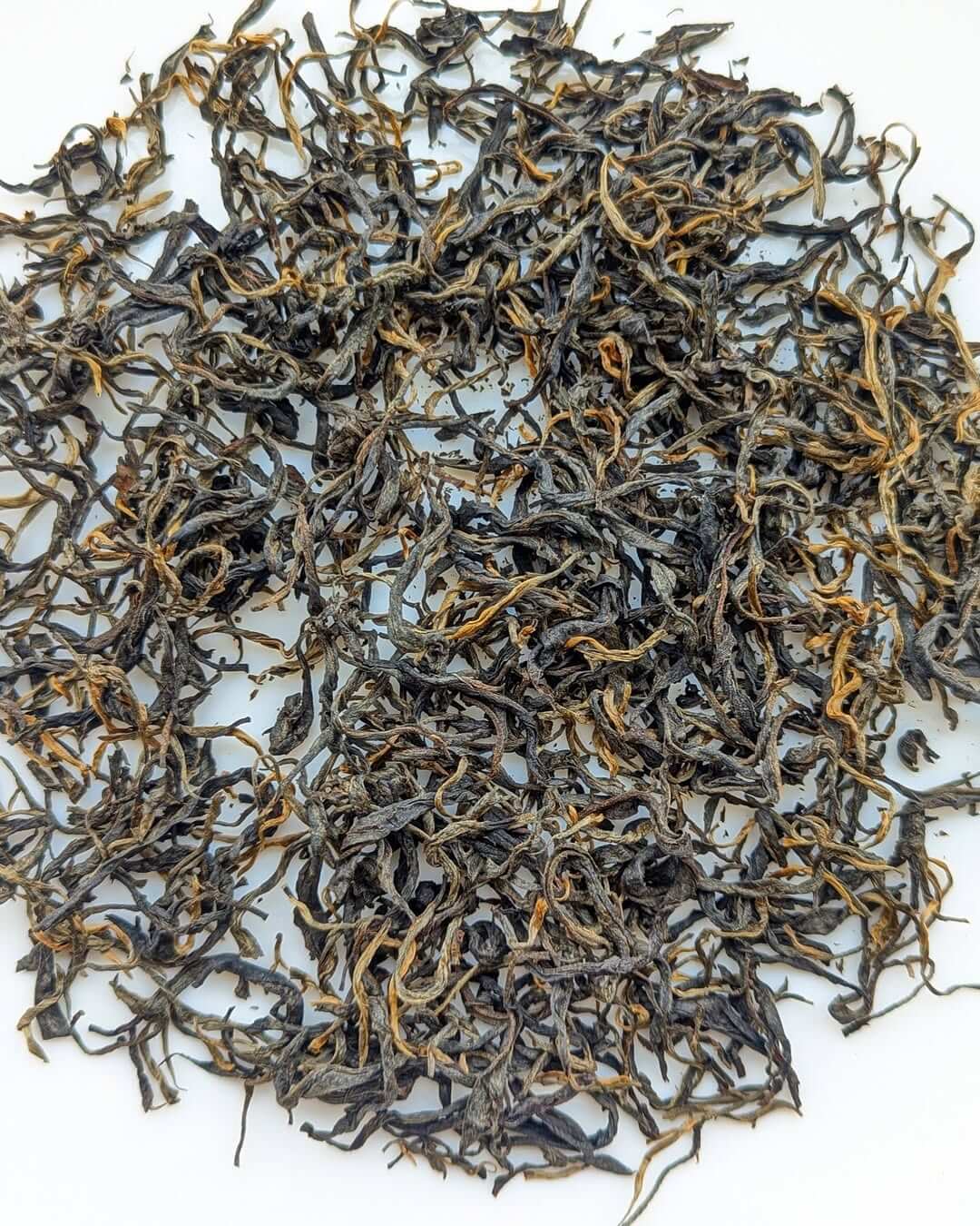 Loose leaf P-126 Clonal Tippy Reserve Organic Black Tea, showcasing premium quality handcrafted tea leaves.